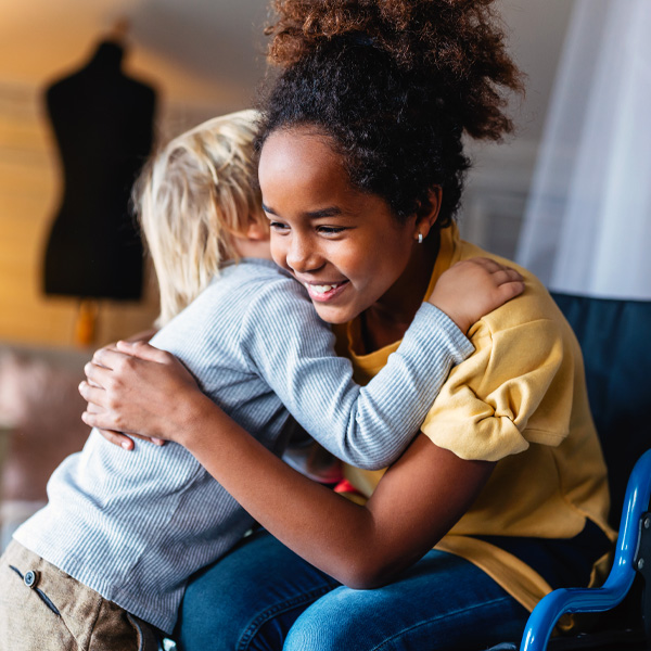 Two kids hugging each other 