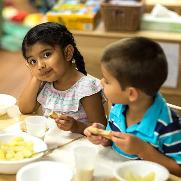 Boy and girl enjoying lunch