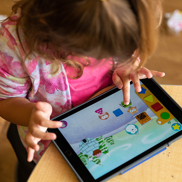 A young girl working on her iPad