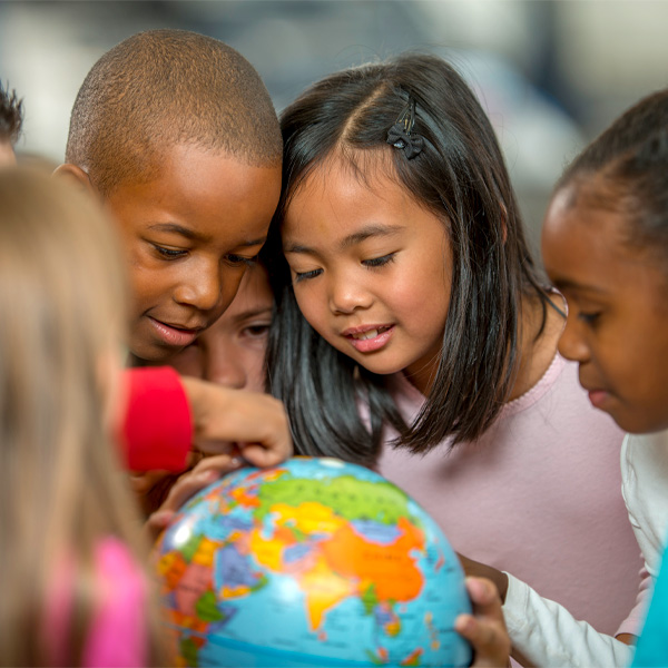 Group of kids looking at a globe
