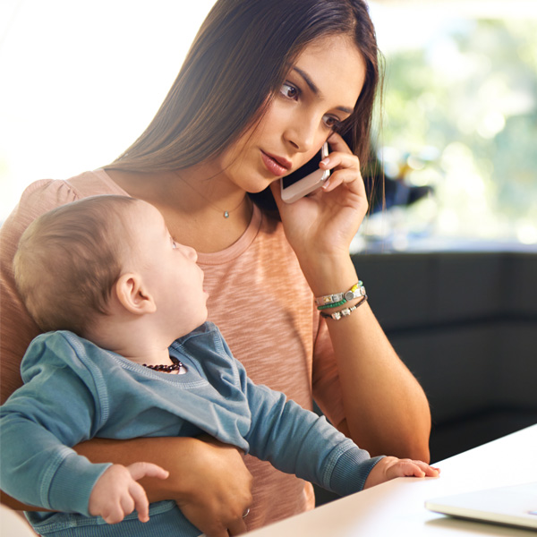 Mom on the phone with baby on her lap