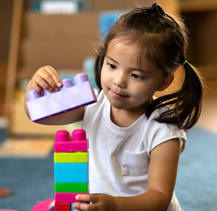 A girl playing with legos