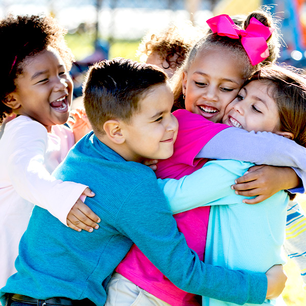 A group of kids hugging each other