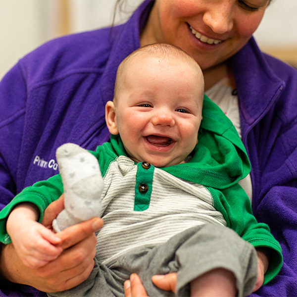 Teacher Holding Smiling Baby