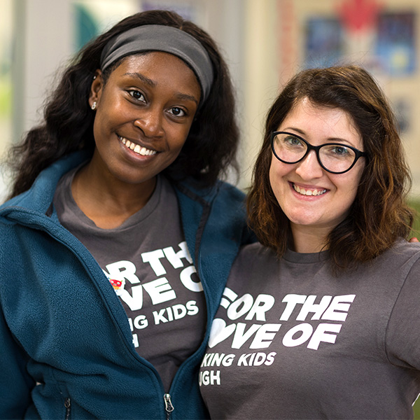 Two teachers posing for a picture smiling